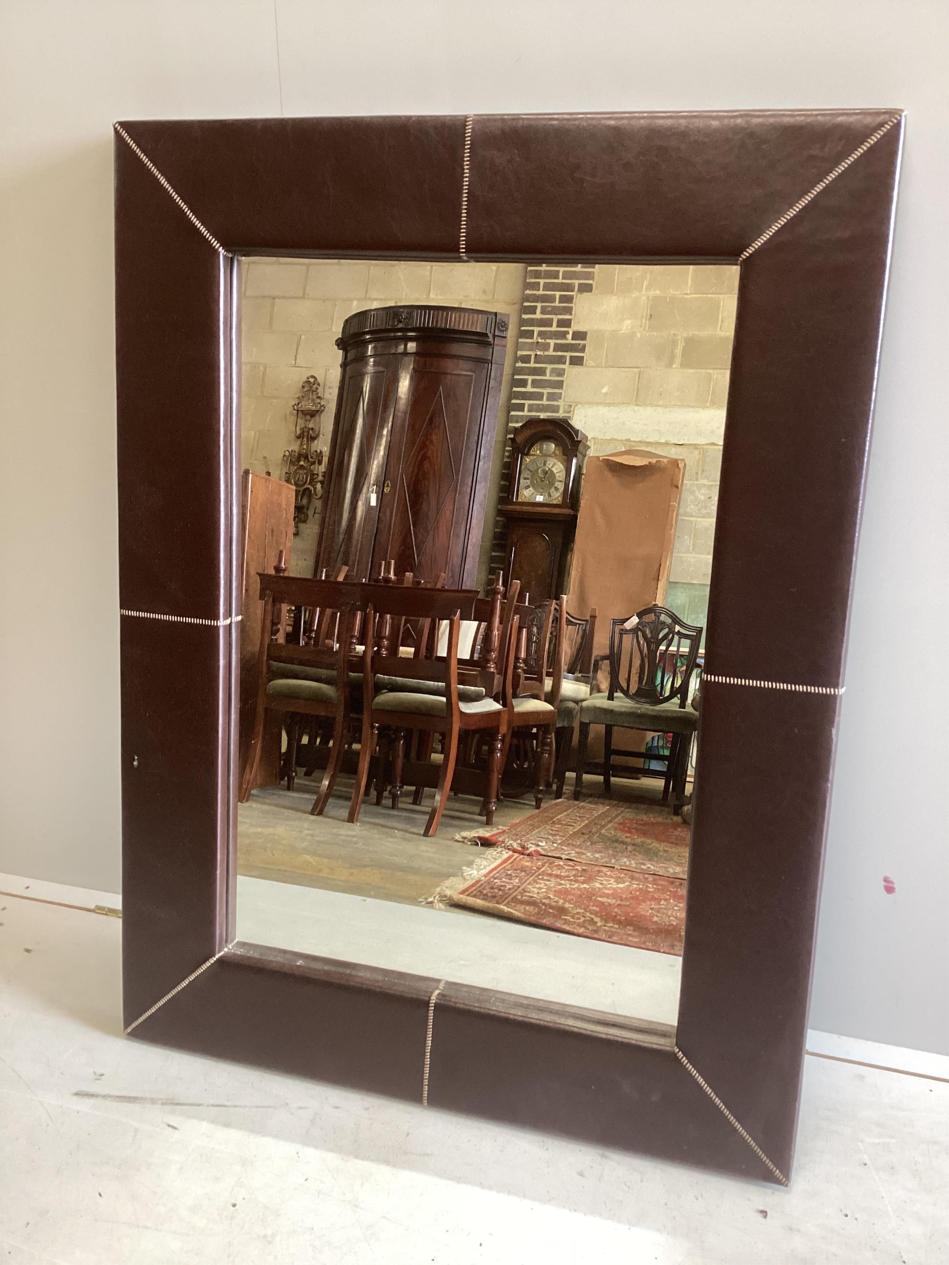 A Liberty style leather framed wall mirror, width 90cm, height 120cm. Condition - fair